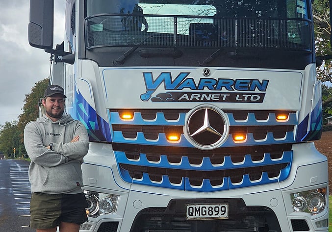 Liam standing in front of the new Warren Arnet Truck.