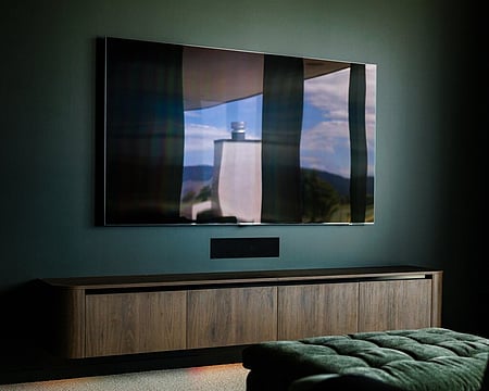 This forest-green entertainment room creates a cozy and inviting space inspired by nature in this high-end build in Matamata