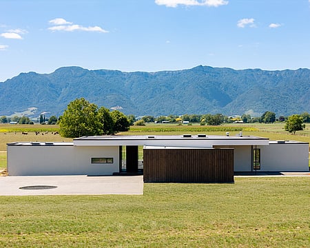 Custom-built outdoor fireplace with simple brick design makes it easy to enjoy the outdoors all winter in the Waikato