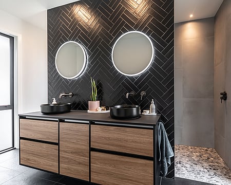 Luxury black bathroom with wood tones creates a deeply relaxing, cocoon-like feel in this awarding-winning new house build