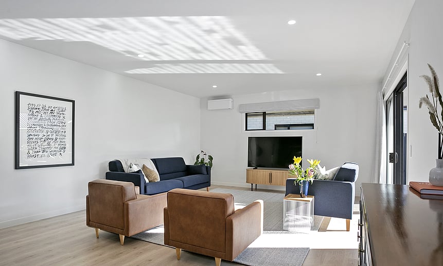 Simple windows are designed to provide privacy while maximizing light in this lounge. Choose design and build custom houses.