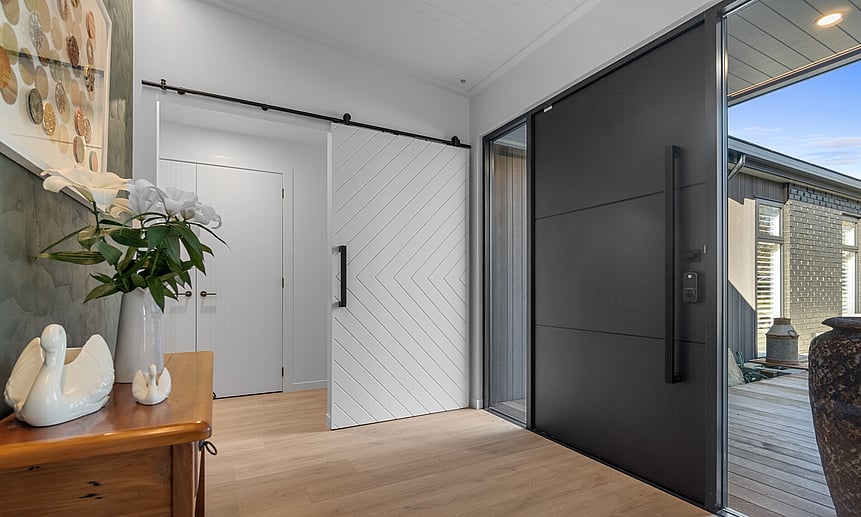 Bespoke large front door and uniquely designed entrance with contrasting colours and patterns makes this home one-of-a-kind