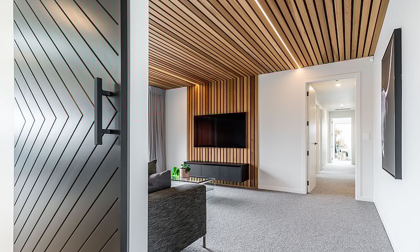 Cleverly designed lines adorn this entertainment room with wooden ceiling panel & strip lighting built by Linecrest Homes.