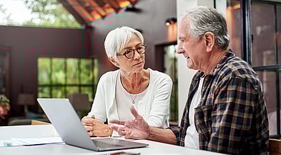 Young women sitting by herself looking at computer screen