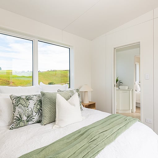 Main bedroom of the tiny home cabin with freshly made bed