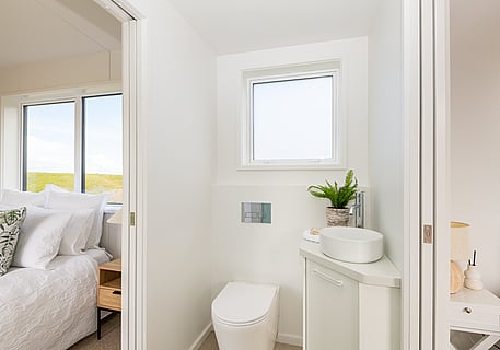 toilet and vanity inside the tiny home cabin