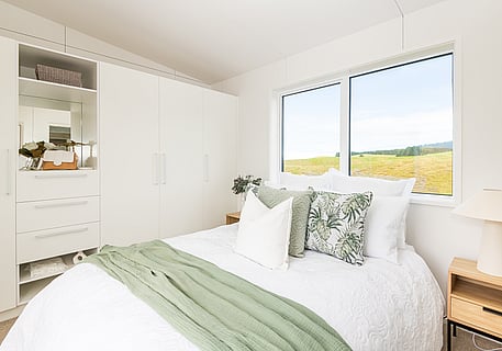 Bed and storage cupboards in bedroom