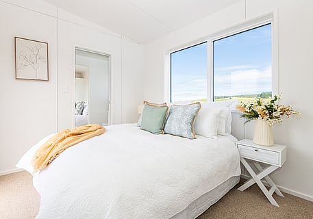 nicely made bed in the tiny home cabin