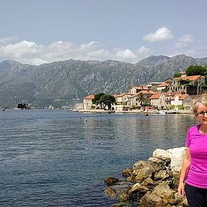 Woman standing by water in Prevast, Montenegro.