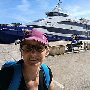 Woman standing in front of a ferry to the Dalmatian Islands.
