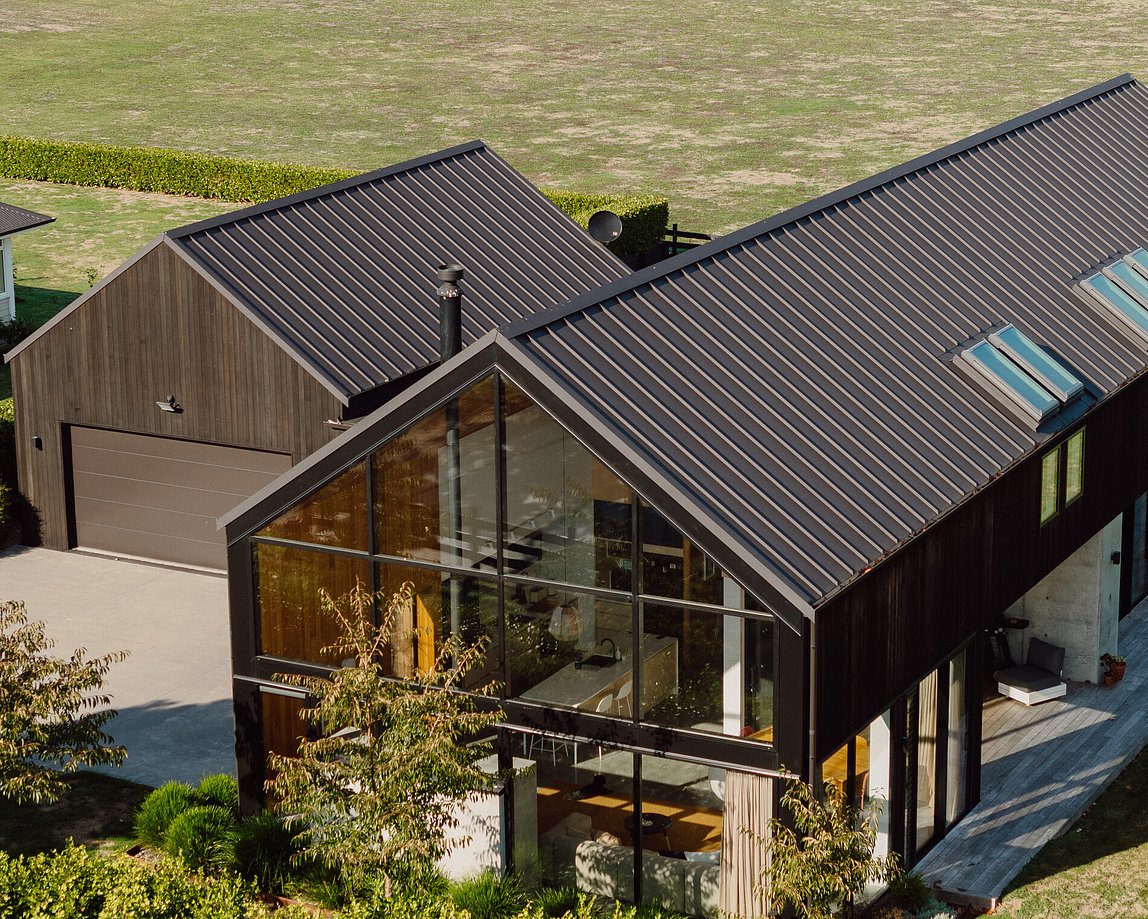 Rural architectural home near Matamata with dark timber cladding and large glazing built by Tauranga architectural builder MB Construction