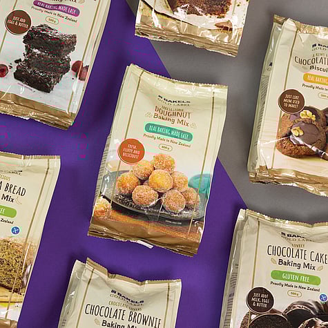 Packaging design of Bakels Gold Label Baking mixes on display against a grey and purple backdrop.