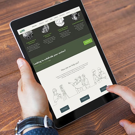 A person holds a tablet displaying the RPC website, showing services like surveying and planning, with a clean design and green accents