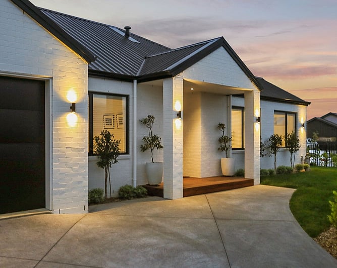 outside of new white brick house in the evening