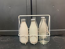 Milk bottles - 5 bottles in carrier, 3 are coloured white