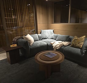 Poolside lounge with large glazing and contemporary seating overlooking the pool in the Ocean Beach Road architectural coastal home in Mount Maunganui, built by MB Construction.