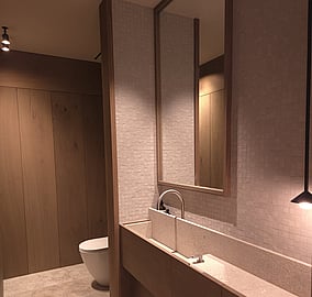 Powder room with wall-mounted basin, tiled splashback and contemporary fittings in the Ocean Beach Road architectural coastal home in Mount Maunganui, built by MB Construction.
