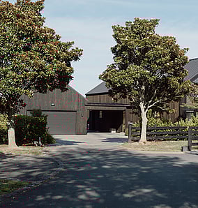 Barn-style architectural rural home near Matamata with cedar cladding, gabled roofline and wide verandah, built by MB Construction, residential builders for Matamata and the Bay of Plenty.