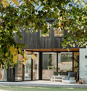 Barn-style architectural rural home near Matamata with cedar cladding, gabled roofline and lawn frontage, built by MB Construction, residential builders for Matamata and the Bay of Plenty.