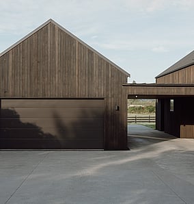 Barn-style architectural rural home near Matamata with cedar-clad garage and barn-style form, built by MB Construction, residential builders for Matamata and the Bay of Plenty.