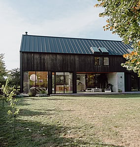 Barn-style architectural rural home near Matamata with cedar cladding, gabled elevation, lawn and landscaping, built by MB Construction, residential builders for Matamata and the Bay of Plenty.