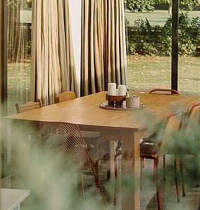 Interior dining detail in a barn-style architectural rural home near Matamata with timber finishes and large glazing to the rural outlook, built by MB Construction, residential builders for Matamata and the Bay of Plenty.