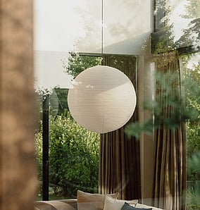 Interior living space in a barn-style architectural rural home near Matamata with feature pendant light, timber finishes and large glazing to the rural outlook, built by MB Construction, residential builders for Matamata and the Bay of Plenty.