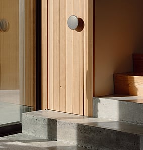 Entry of an architectural rural home in Matamata with concrete stairs, built-in coat cupboard and timber detailing, built by MB Construction.