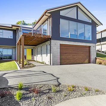 Double story New Zealand home with upper deck.