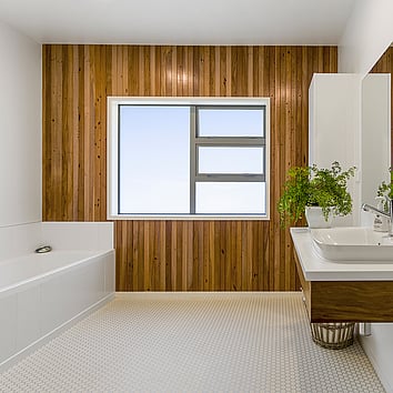Modern bathroom with a timber wall