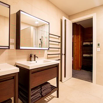 modern bathroom with twin freestanding vanities.