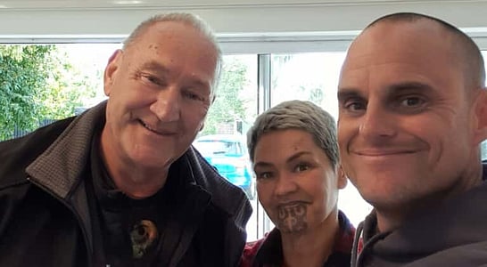 Community members standing together in solidarity for healing and awareness.