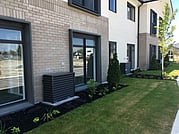 Standard Heat pump cover outdoor unit in garden. Retirement Village