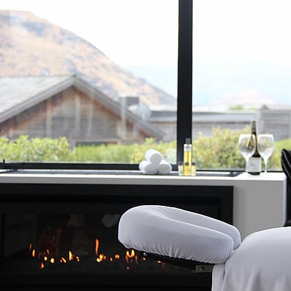 A treatment bed set up in a home with a fire gently burning in the background.