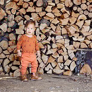 Childrens fashion photography for Kauri and Sons firewood stack location