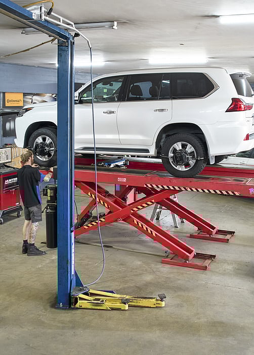 Cambridge Tyre and Alignment - Car on a hoist with wheels being aligned