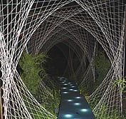 A blue water-filled path links through artfully woven wool panels.