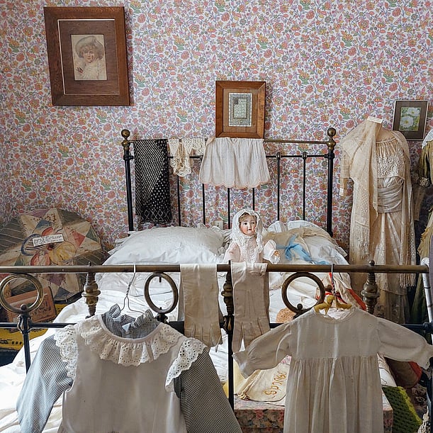 Child's bedroom showing Victorian clothing and furnishings in Martinborough Museum