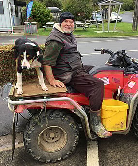 Local farmer sitting with his dog and a haybale on a quadbike in the Kuaotunu Village on the Coromandel Peninsula