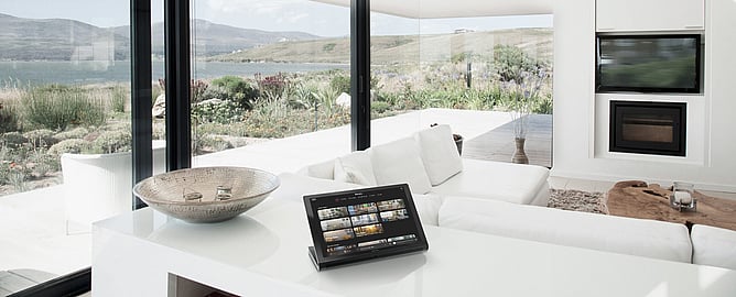 Crestron Home automation touchscreen controlling lighting and climate