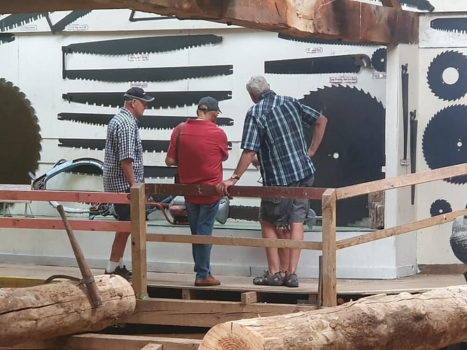 Three old ex farm bodies reminiscing on when they were made to help their fathers work one of these crosscut saws (many years ago)