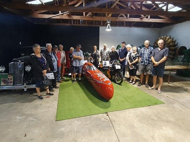 Mandatory participation photo beside two unique electric bikes built and ridden by a couple from Tokoroa. The red machine held the electric bike world land speed record for a number of years at 434km/hr with a lady rider.
