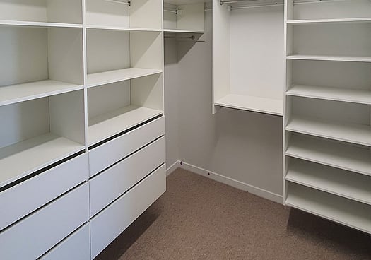 Text overlay and image showing a white walk-in Wardrobe Design.