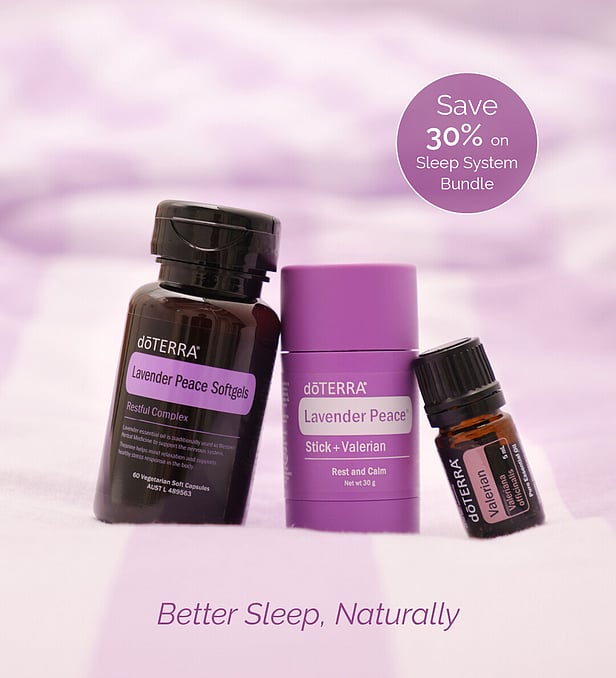 doTERRA sleep system including lavender peace softgels, lavender peace stick with valerian and valerian essential oil on a pastel purple background