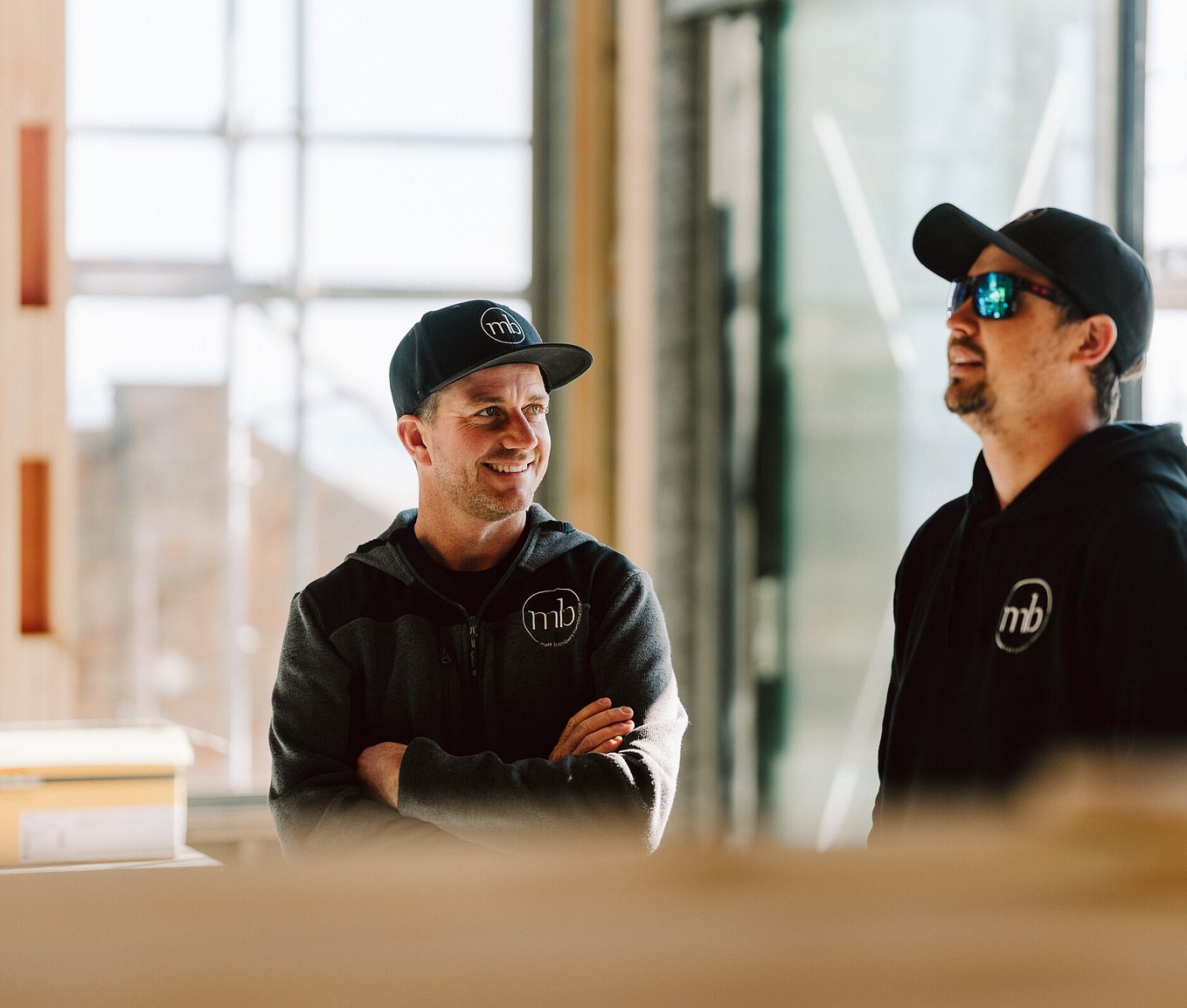 MB Construction team providing renovation project management on site in Mount Maunganui, Tauranga builders discussing architectural home project.