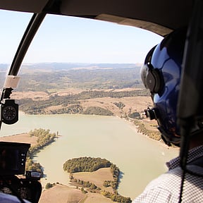 helicopter over truck on farm
