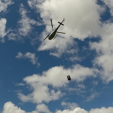 helicopter lifting over forrest