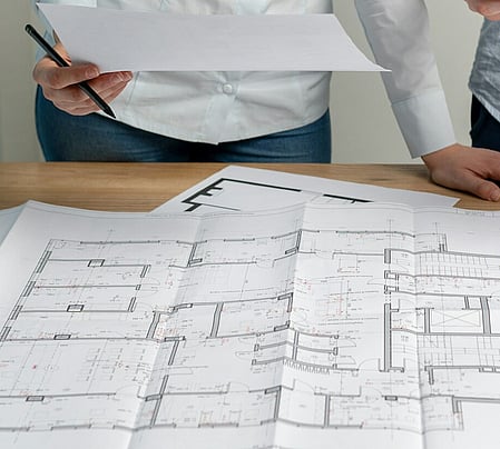A person looking over house plans.
