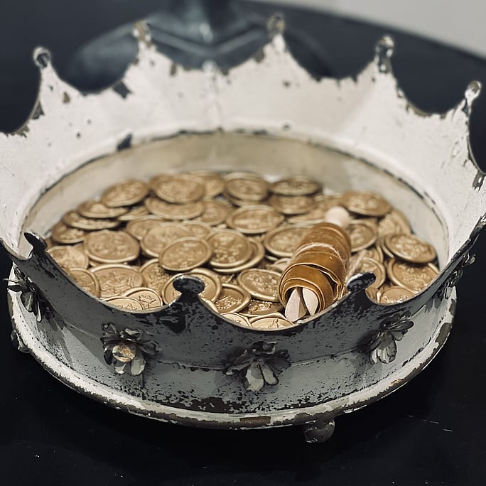 A crown full of homemade gold wax seals and gold velvet ribbon