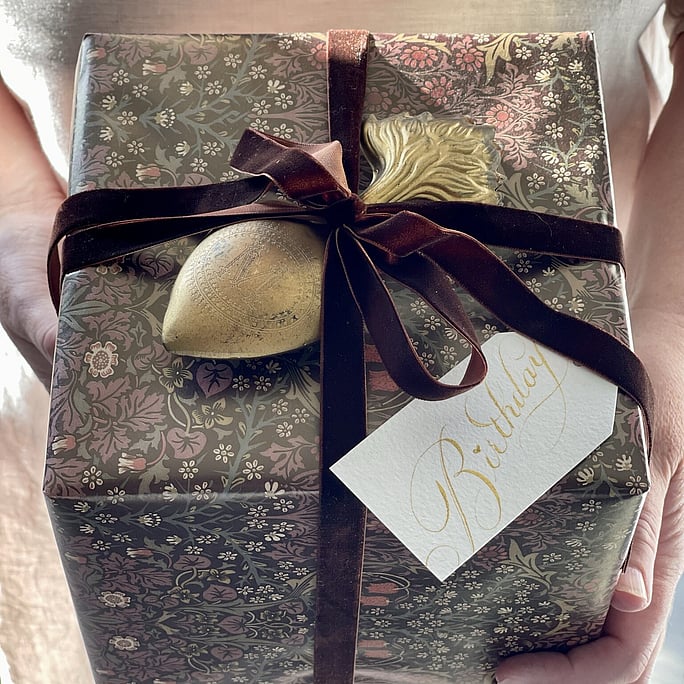 A gift wrapped in a morris william print and embellished with velvet ribbon. Features our birthday gift tag with its birthday wishes on the back.